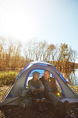 Buy stock photo Shot of a senior couple camping together in the wilderness