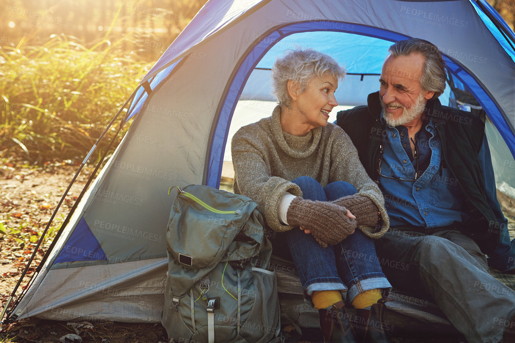 Buy stock photo Shot of a senior couple camping together in the wilderness