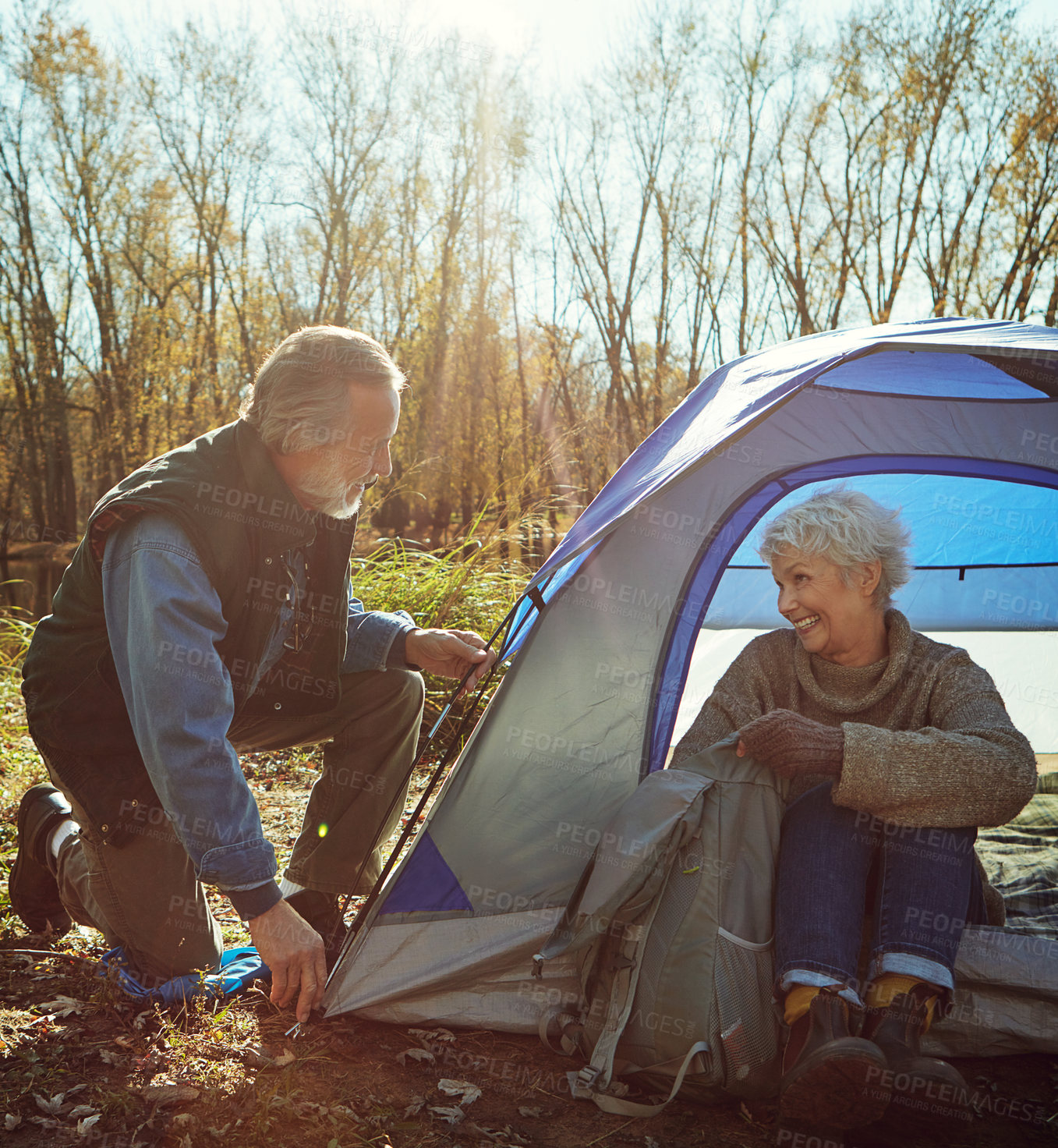 Buy stock photo Shot of a senior couple camping together in the wilderness