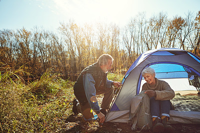 Buy stock photo Shot of a senior couple camping together in the wilderness