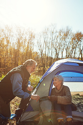 Buy stock photo Shot of a senior couple camping together in the wilderness