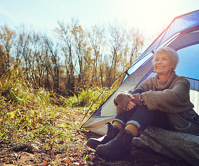 Buy stock photo Camp, senior woman and fresh air in tent, smile and outdoor to enjoy nature, freedom and sunshine. Retirement, hobby and morning at campsite, happy and healthy with wellness and relaxing natural view