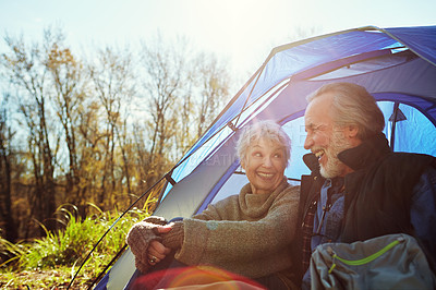 Buy stock photo Shot of a senior couple camping together in the wilderness