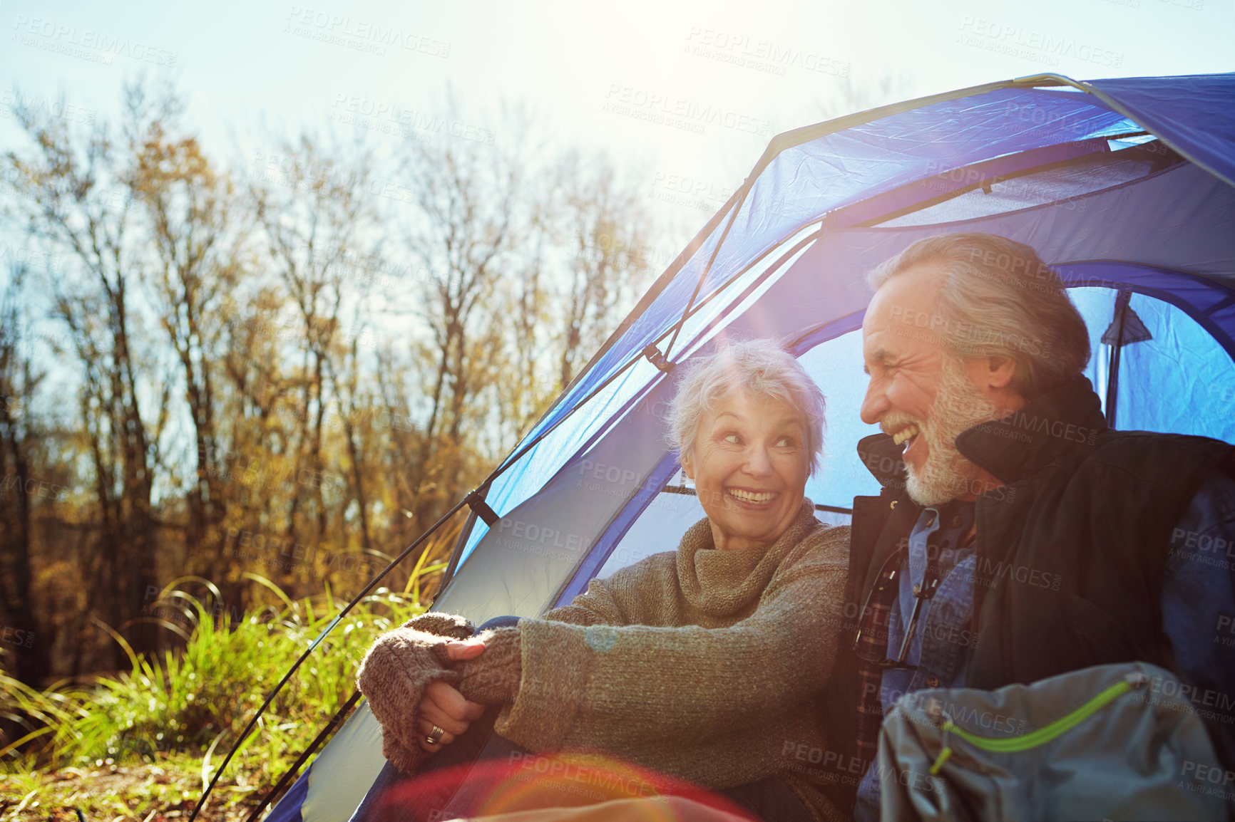 Buy stock photo Shot of a senior couple camping together in the wilderness