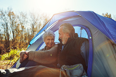 Buy stock photo Shot of a senior couple camping together in the wilderness