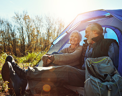 Buy stock photo Shot of a senior couple camping together in the wilderness