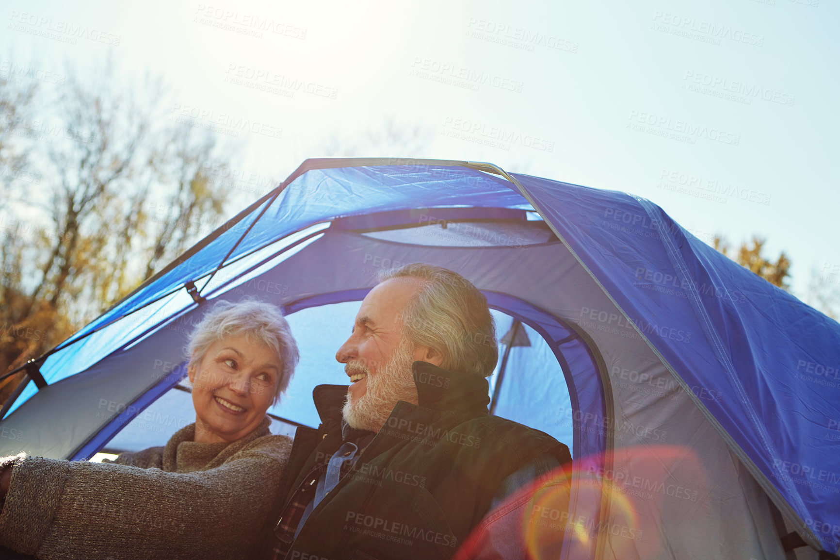 Buy stock photo Shot of a senior couple camping together in the wilderness