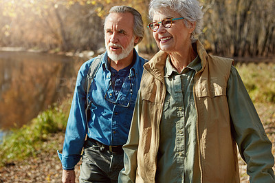 Buy stock photo Shot of a happy senior couple exploring nature together