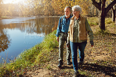 Buy stock photo Shot of a happy senior couple exploring nature together