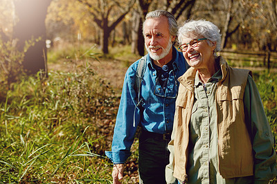 Buy stock photo Shot of a happy senior couple exploring nature together