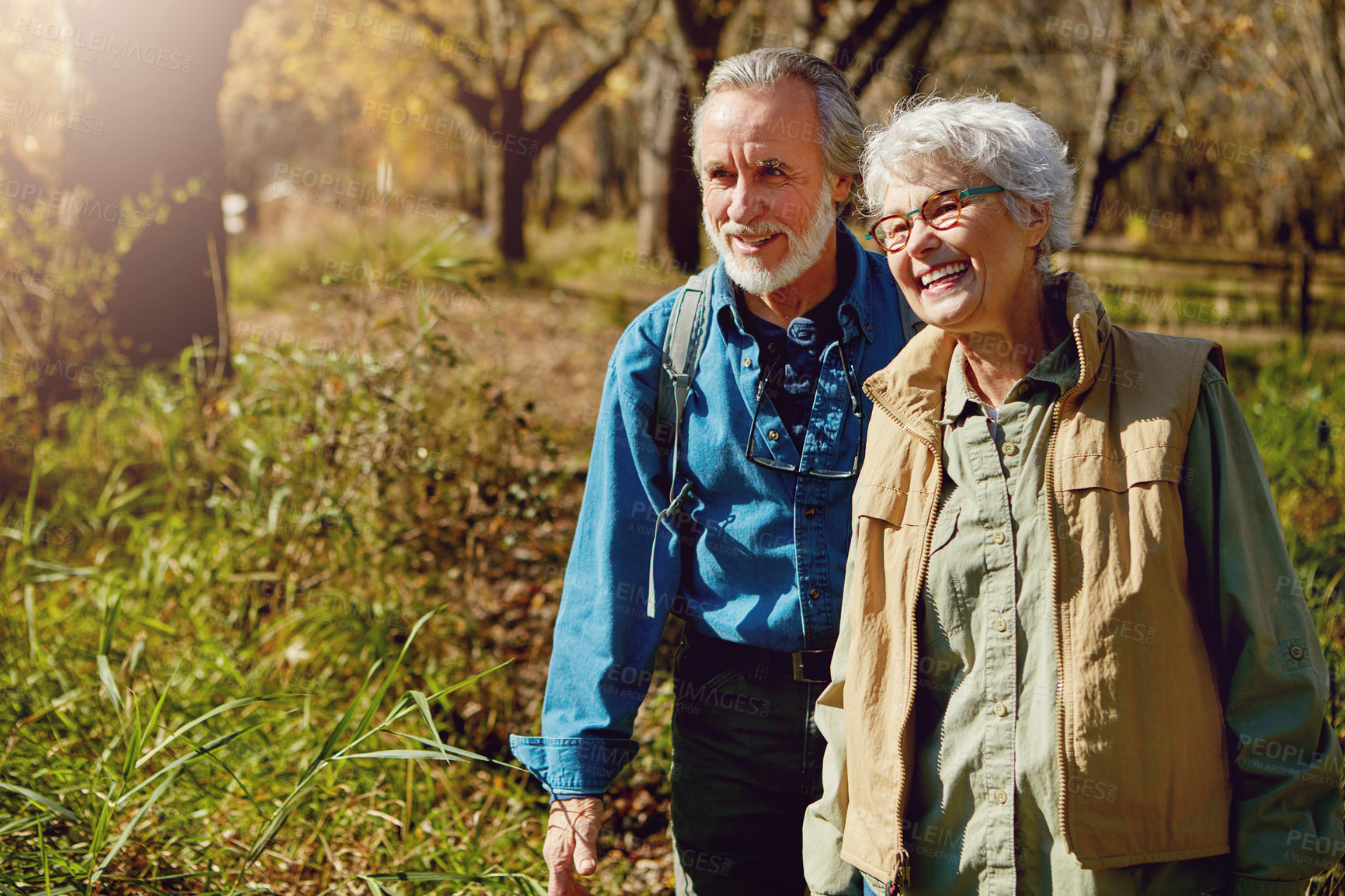 Buy stock photo Shot of a happy senior couple exploring nature together