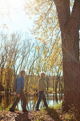 Buy stock photo Shot of a happy senior couple exploring nature together