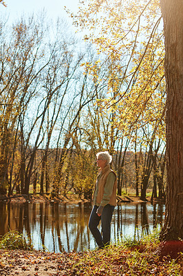 Buy stock photo Shot of a happy senior couple exploring nature together