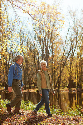 Buy stock photo Shot of a happy senior couple exploring nature together