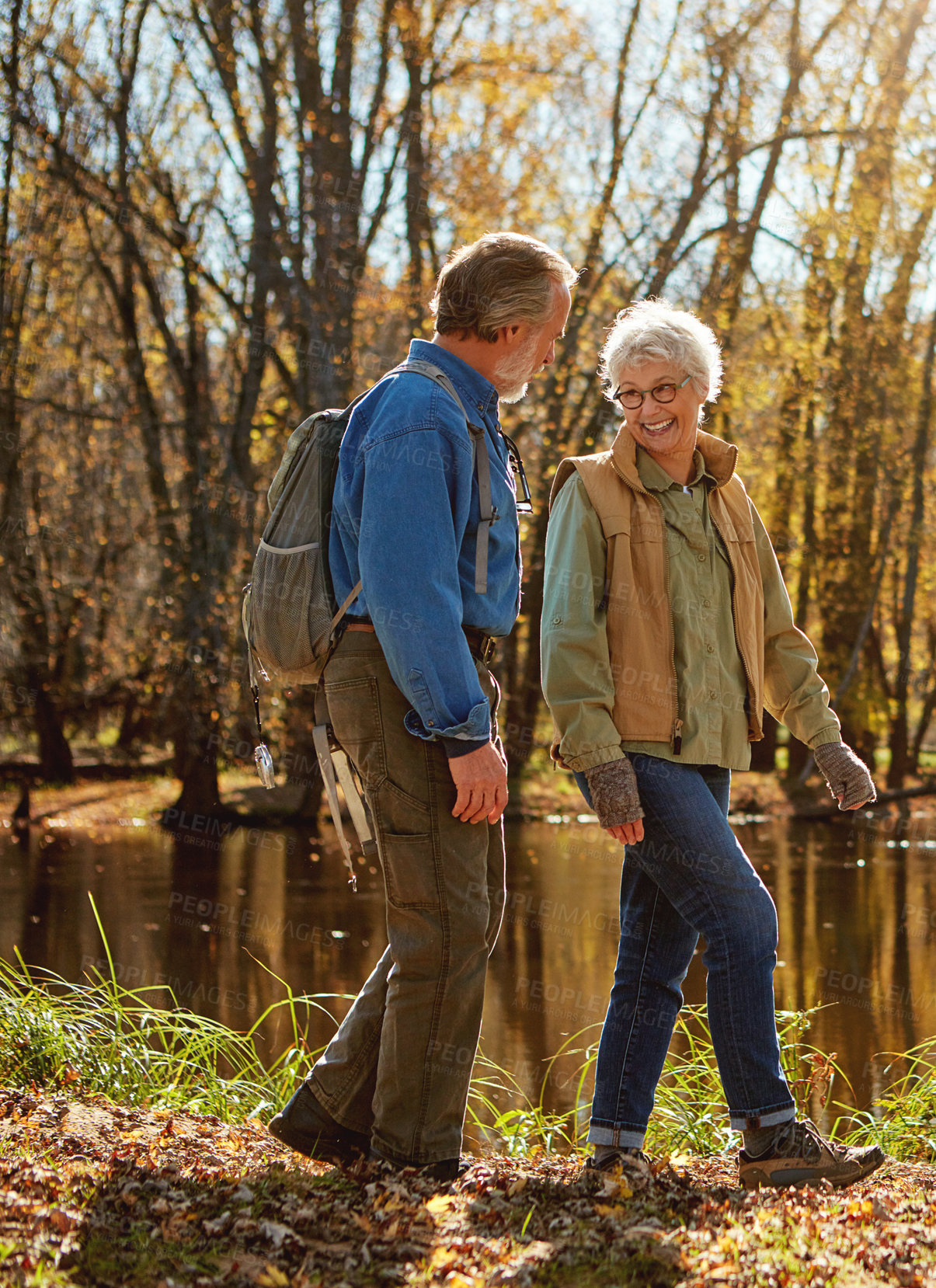 Buy stock photo Shot of a happy senior couple exploring nature together