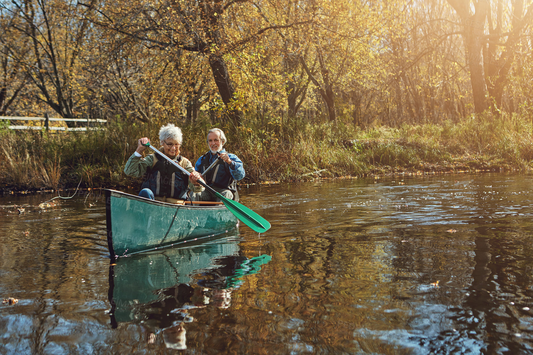 Buy stock photo Senior couple, kayak and rowing for holiday, travel or summer vacation in water outdoor together in river. Man, woman and canoe boat in lake on transport for adventure, exercise and happy in nature