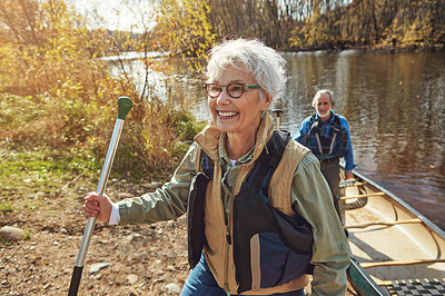 Buy stock photo Shot of a senior couple going for a canoe ride on the lake