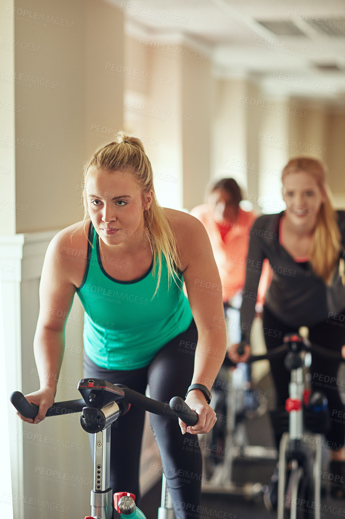 Buy stock photo Woman, exercise bike and gym for spinning, training and cardio for fitness or cycling class. Female person, riding and stationary machine for workout challenge, aerobic instructor and equipment