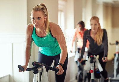 Buy stock photo Woman, exercise bike and coach for cardio, training and cycling for fitness or spin class. Female person, riding and stationary machine for workout challenge, aerobic instructor and equipment at gym