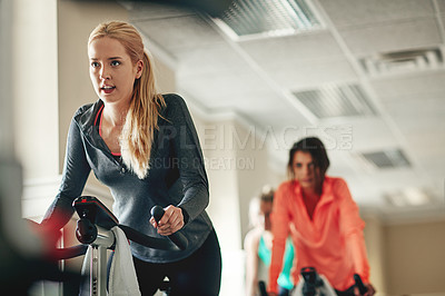 Buy stock photo Woman, exercise bike and class for cardio, training and cycling for fitness or spinning studio. Female person, riding and stationary machine for workout challenge, aerobic instructor and equipment