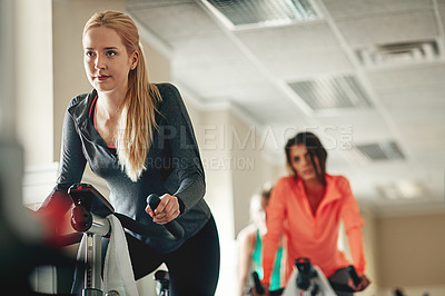 Buy stock photo Woman, aerobics bike and coach for cardio, training and support for fitness in cycling class. Female person, riding and stationary machine for workout challenge, spin instructor and equipment at gym