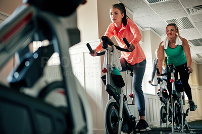 Buy stock photo Woman, cycling and workout with spin class for fitness, training or cardio exercise at indoor gym. Active female person or group of cyclists riding on equipment or bicycle in challenge at health club