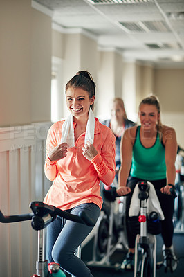 Buy stock photo Happy woman, cycling and cardio with spin class for fitness, training or workout exercise at indoor gym. Active female person or group of cyclists with smile on equipment or bicycle at health club