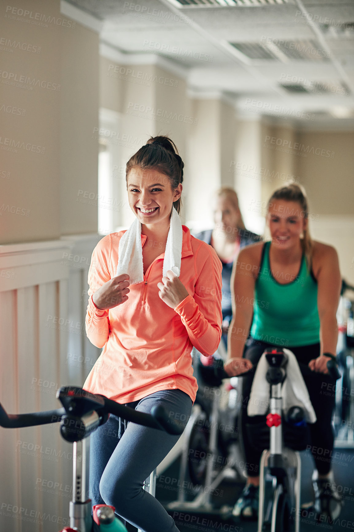 Buy stock photo Happy woman, cycling and cardio with spin class for fitness, training or workout exercise at indoor gym. Active female person or group of cyclists with smile on equipment or bicycle at health club