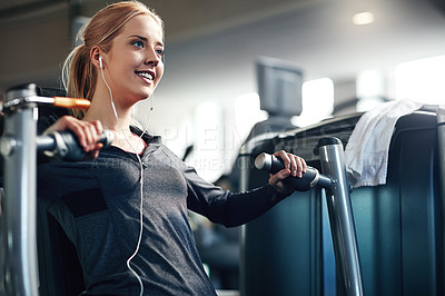 Buy stock photo Gym, woman and happy on chest press machine for workout to exercise for health, fitness and muscles. Female person, smile and earphones with training for wellbeing, wellness and self care in routine