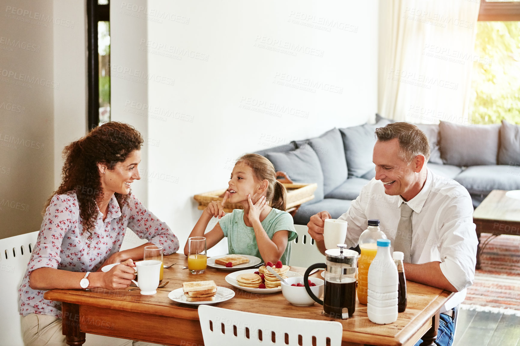 Buy stock photo Breakfast, talk and love with family in home for bonding, happy and nutrition. Pancakes, wellness and morning with parents and child in dining room of house for growth, food and support together