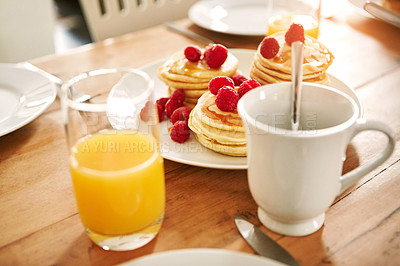 Buy stock photo Closeup shot of pancakes, juice and a mug on a breakfast table