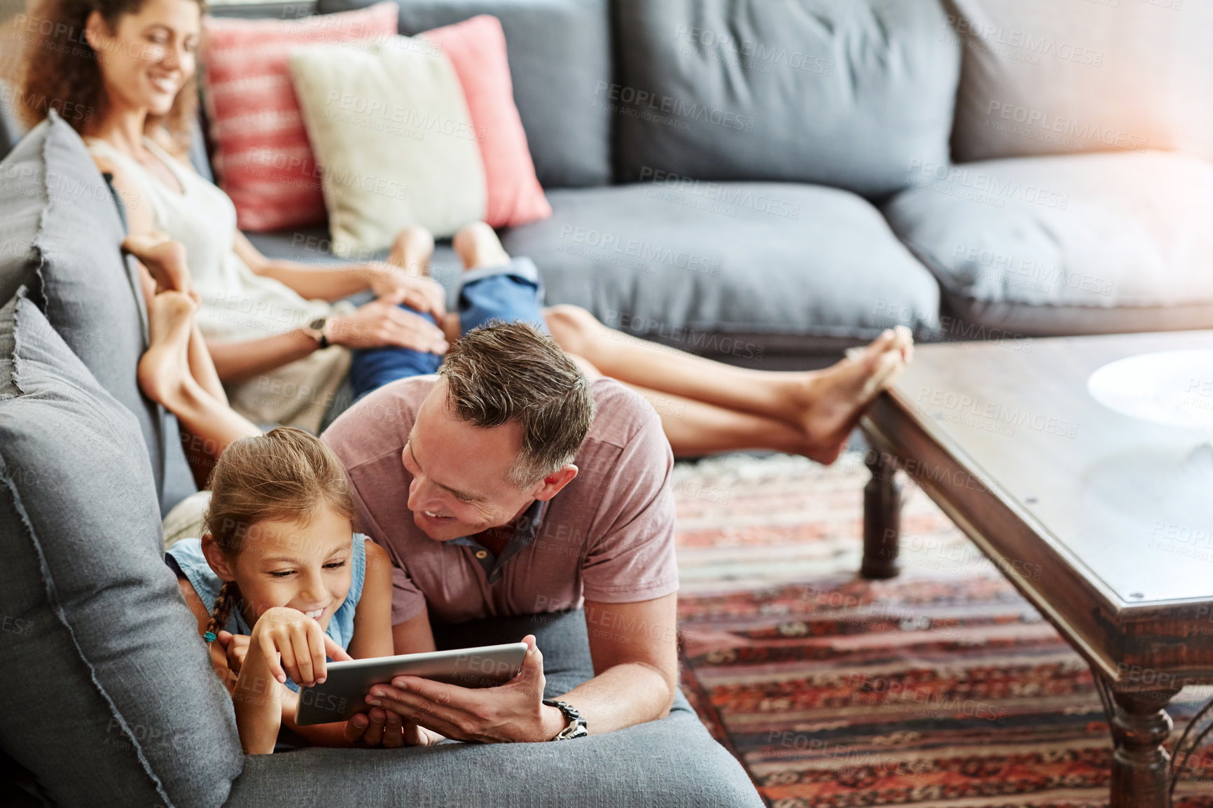 Buy stock photo Woman, man and child with tablet as family on weekend, break at home for e learning or gaming. Excited, people and lounge for relax, together and bonding as parents for growth, development and love
