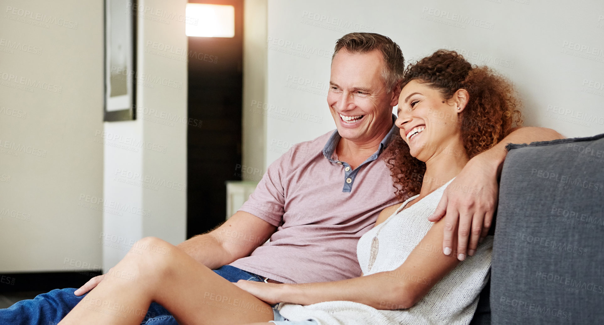 Buy stock photo Smile, relax and love with couple on sofa in home for bonding, support and connection. Happiness, care and commitment with man and woman in living room of apartment for marriage and weekend break