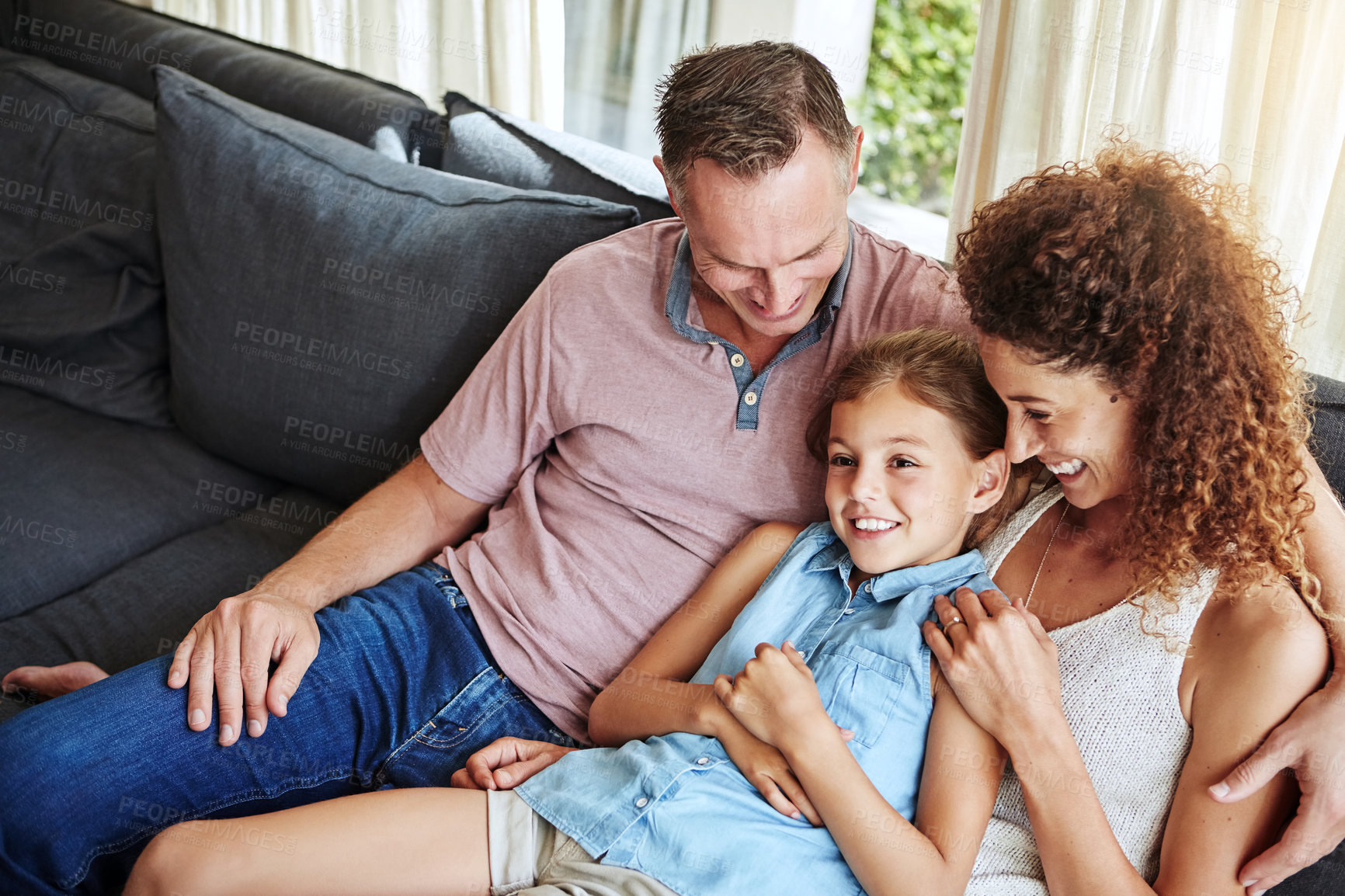 Buy stock photo Shot of a happy family relaxing together at home