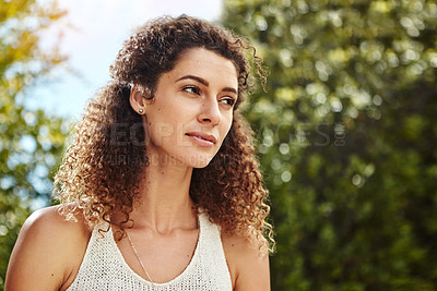 Buy stock photo Shot of an attractive young woman standing outside