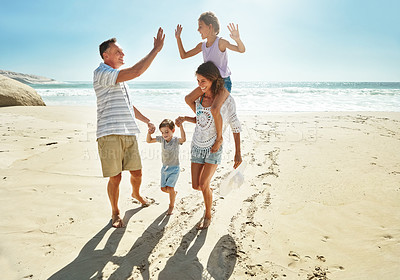 Buy stock photo Parents, children and beach for high five in summer for travel vacation, ocean sunshine or sibling development. Man, woman and kids on sand for holiday relax walking or outdoor, clean air or smile