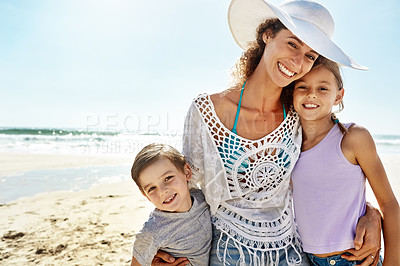 Buy stock photo Portrait of a mother and her two little children enjoying some quality time together at the beach