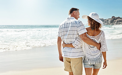 Buy stock photo Shot of a mature couple walking along the beach