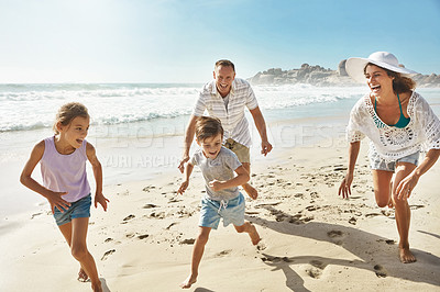 Buy stock photo Shot of a family enjoying some quality time together at the beach
