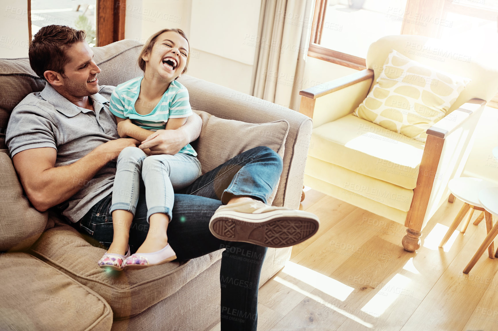 Buy stock photo Shot of a father and his little daughter bonding together at home