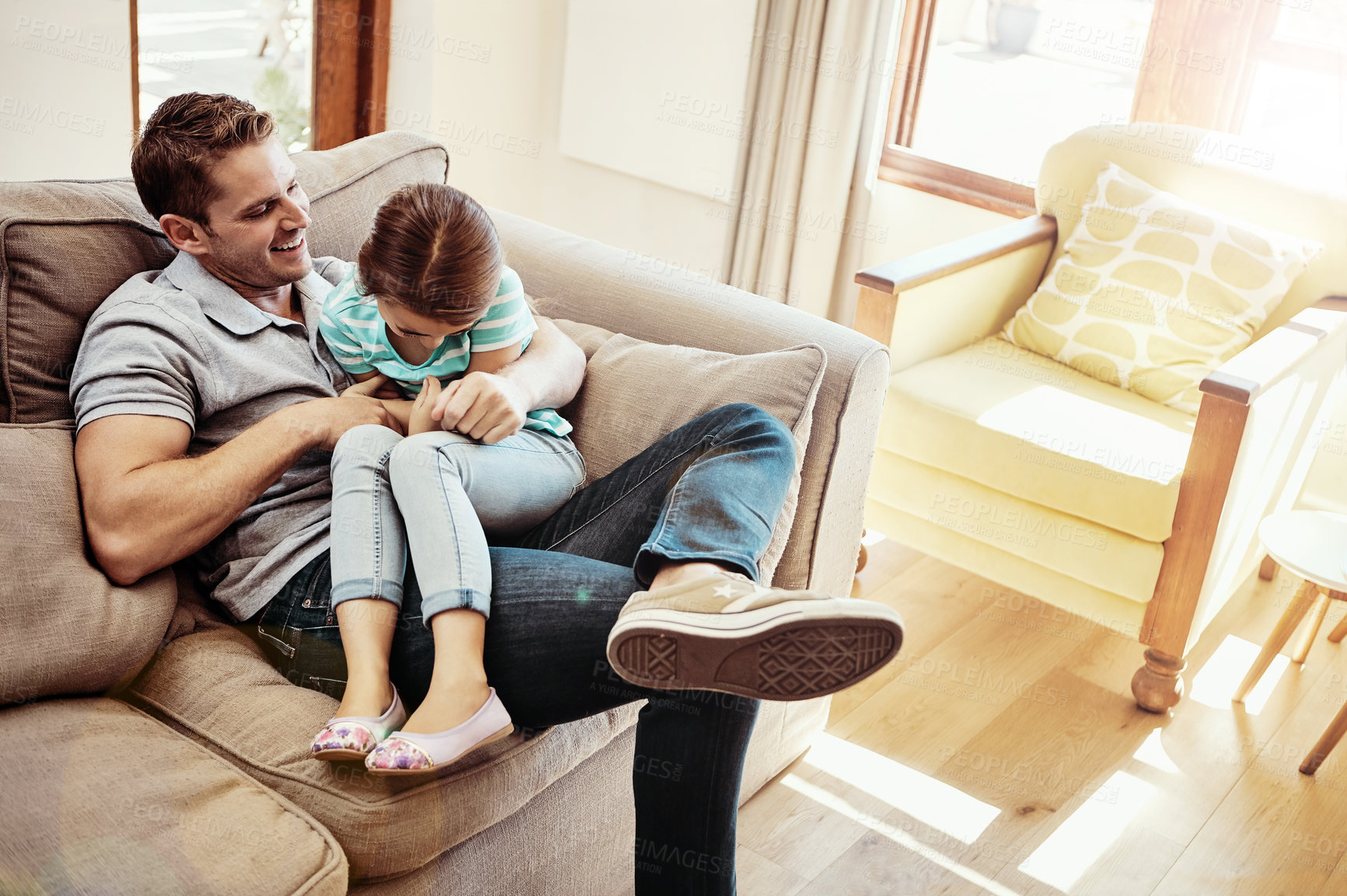 Buy stock photo Shot of a father and his little daughter bonding together at home