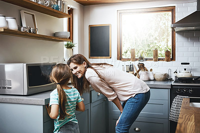 Buy stock photo Shot of a mother bonding with her little daughter at home