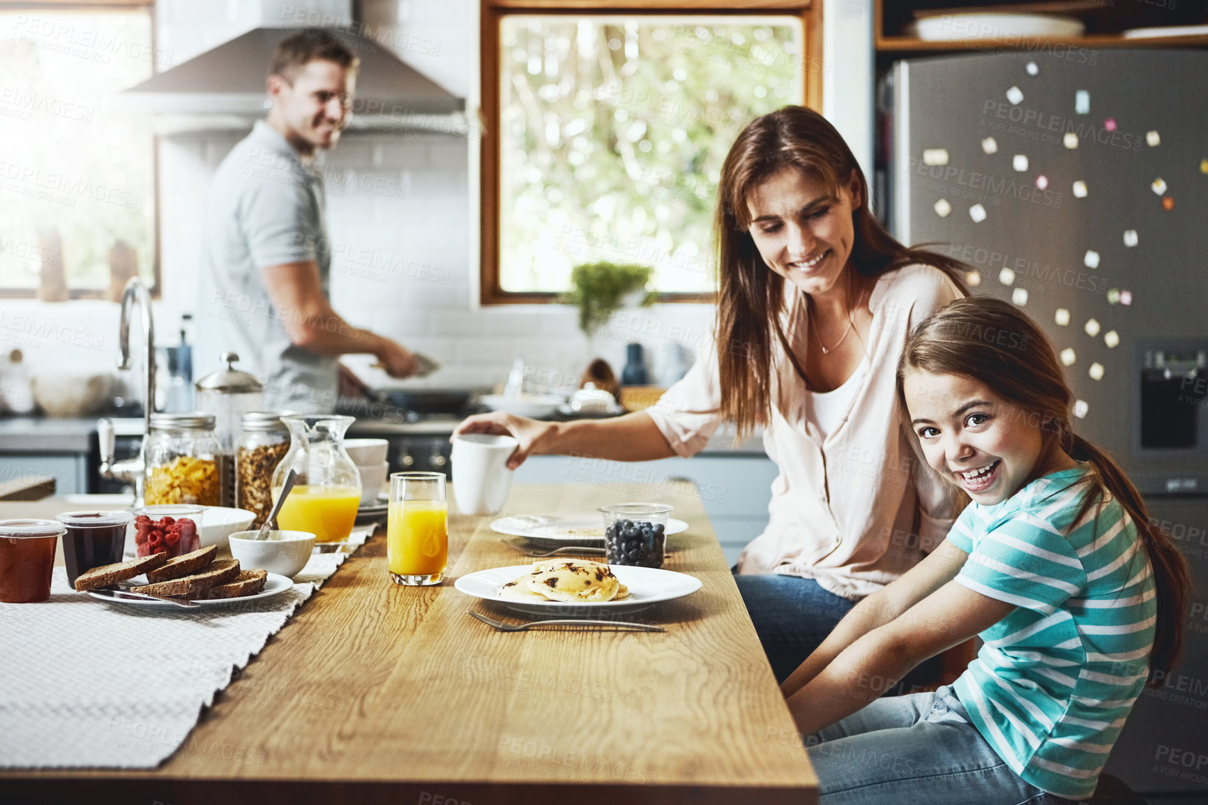 Buy stock photo Love, breakfast food and happy family with children, mother and father, bonding and prepare ingredients. Morning pancakes, cooking and hungry woman, man and daughter in home kitchen eating meal