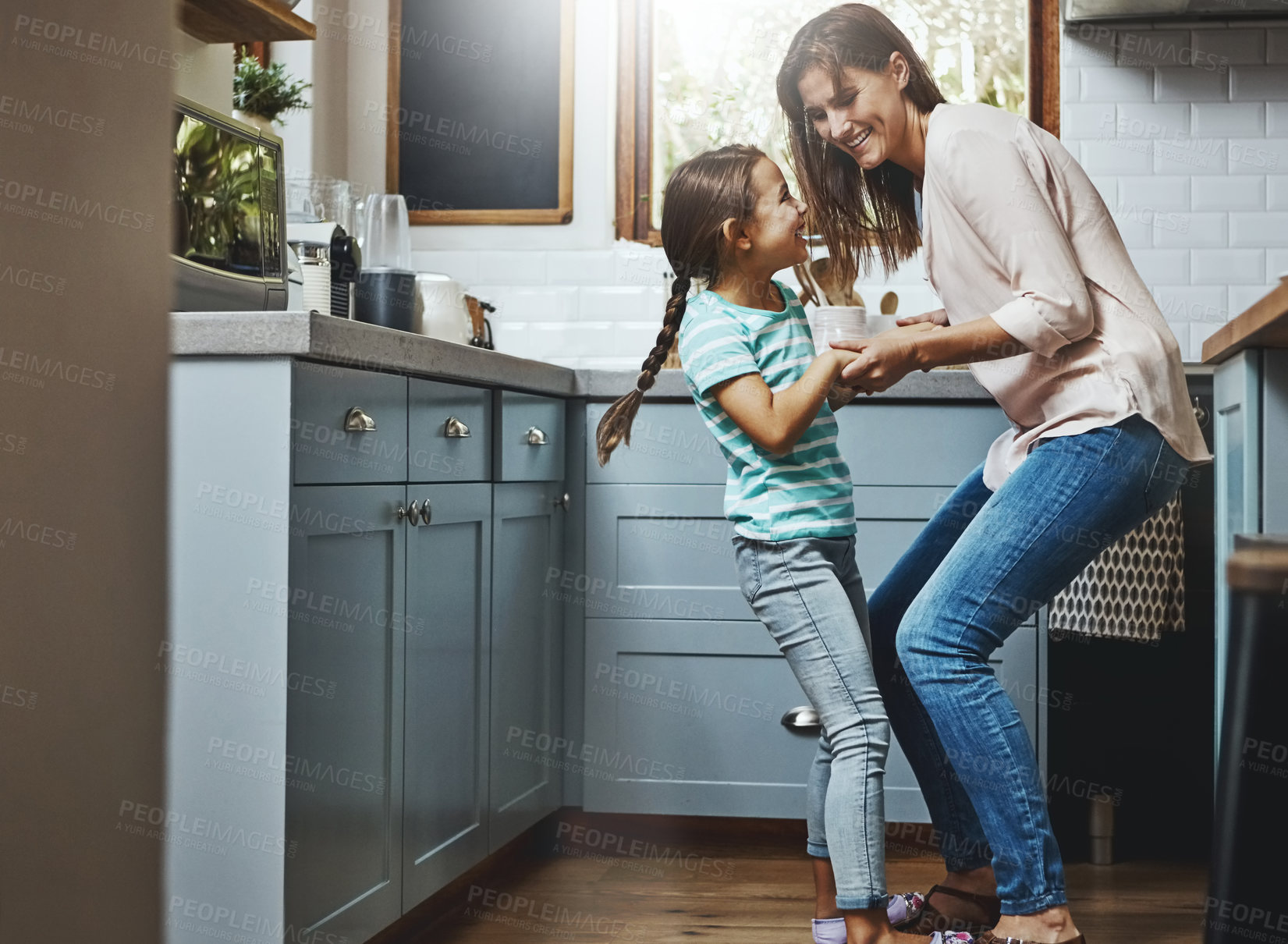 Buy stock photo Happy, mother and daughter with playing in kitchen for weekend fun, support and care in childhood. Smile, love and mom with little girl at family home for funny bonding, humor and morning joy