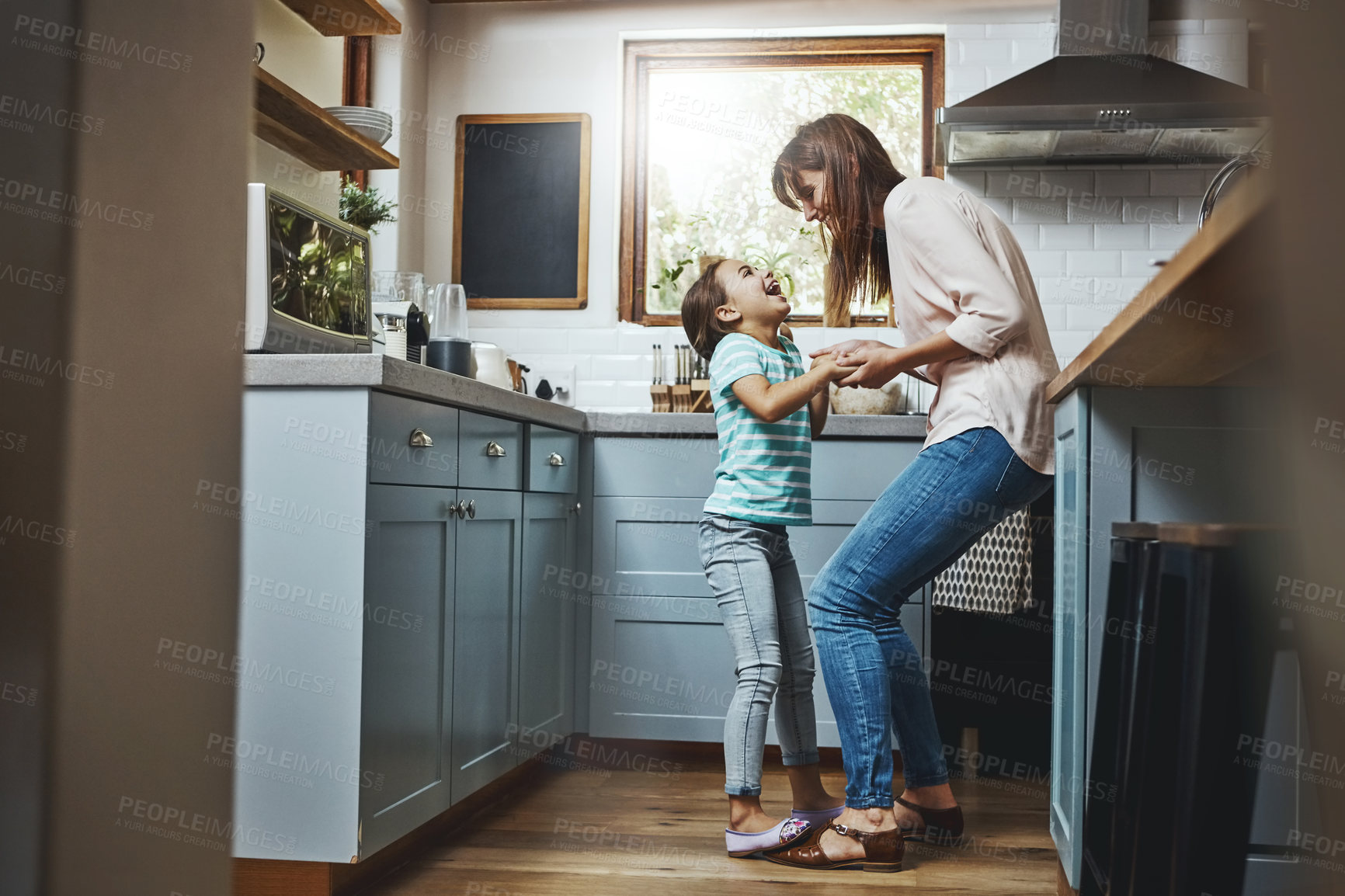 Buy stock photo Dancing, smile and mother with child in kitchen for bonding, fun and listening to music together. Happy, excited and mom teaching girl kid to groove to radio, playlist or song at home in Canada.