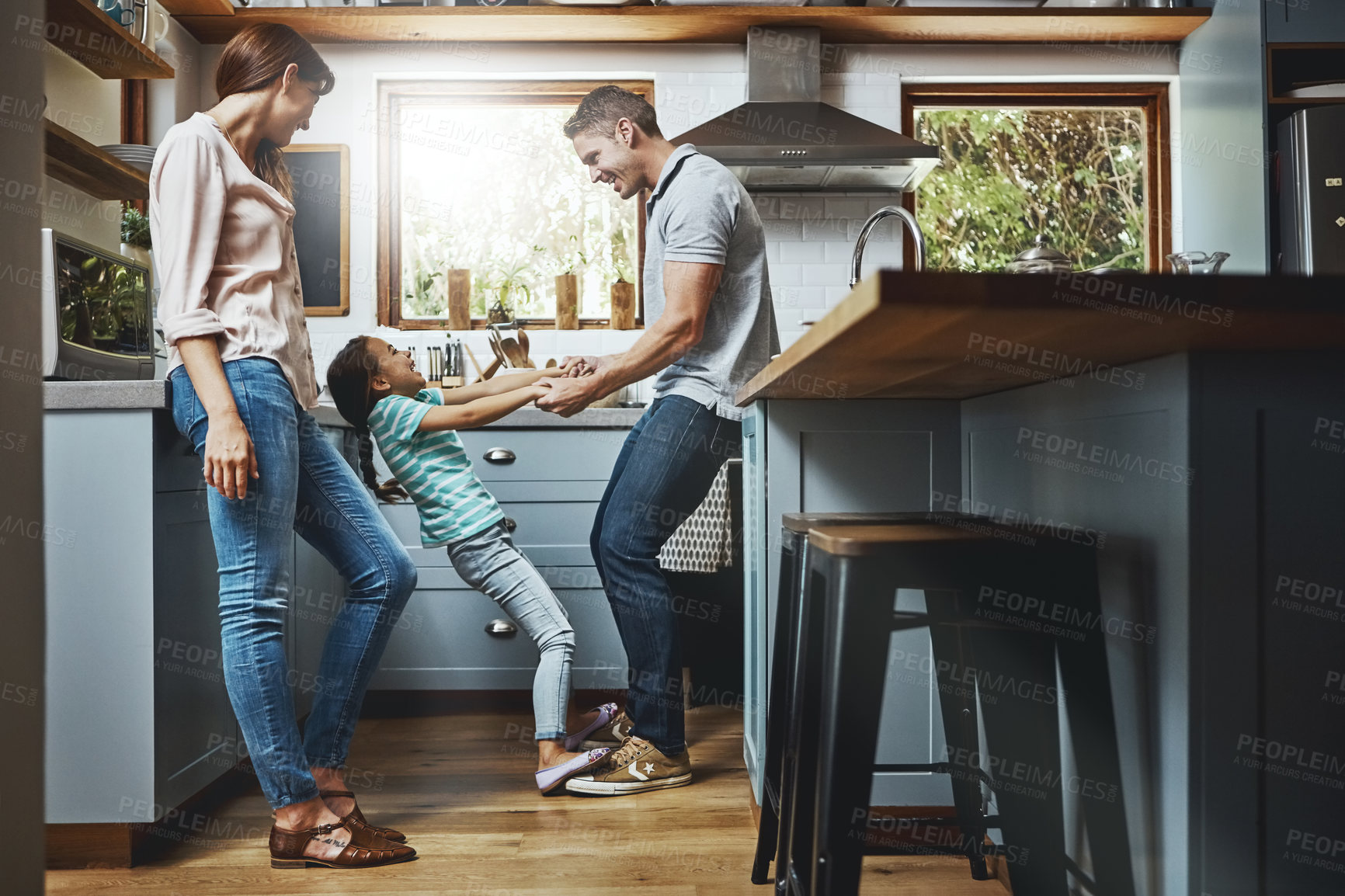 Buy stock photo Kitchen, family and dance together in home or bonding, child and father holdings hands, love and quality time in house. Girl, dad and mom with affection, fun and relax or dancing and laughing