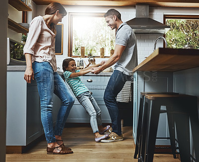 Buy stock photo Family, kitchen and dance together in home or bonding, child and father holdings hands, love and quality time in house. Girl, dad and mom with affection, fun and relax or dancing and laughing