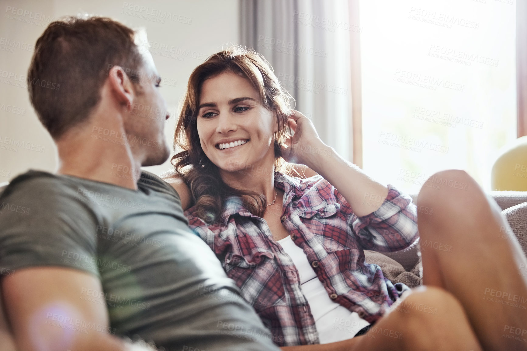 Buy stock photo Couple, love and relax on sofa with smile at home for support, happiness and care in marriage. Peace, calm and man with woman on couch in living room for weekend, romance and bonding together