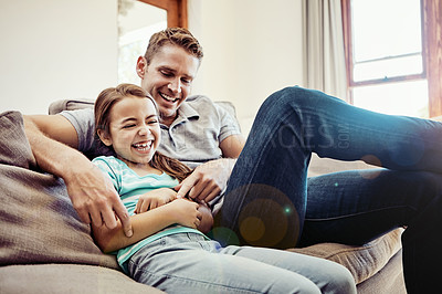 Buy stock photo Shot of a father and his little daughter bonding together at home