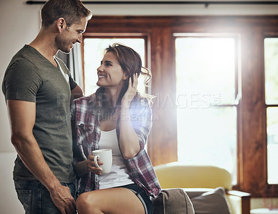 Buy stock photo Shot of a young couple spending a relaxing day together at home